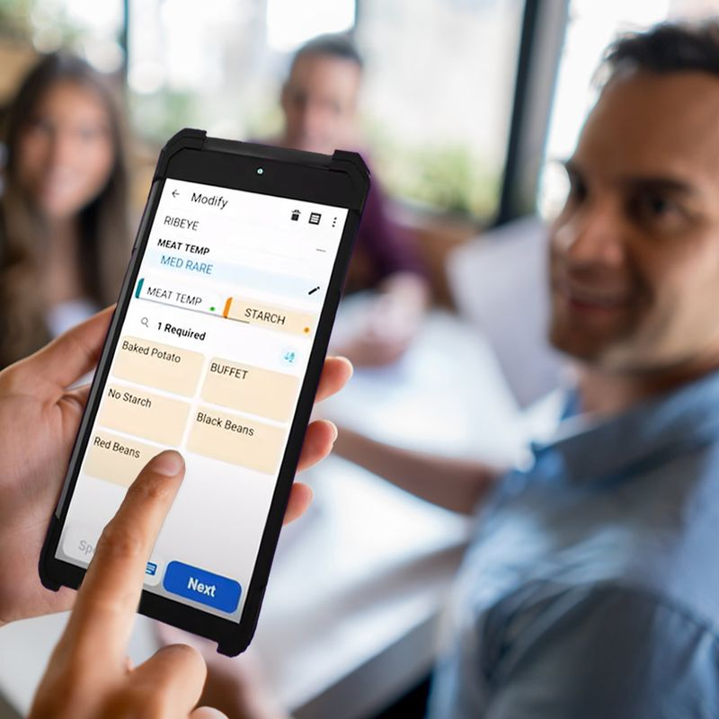 Waiter using handheld to place accurate order